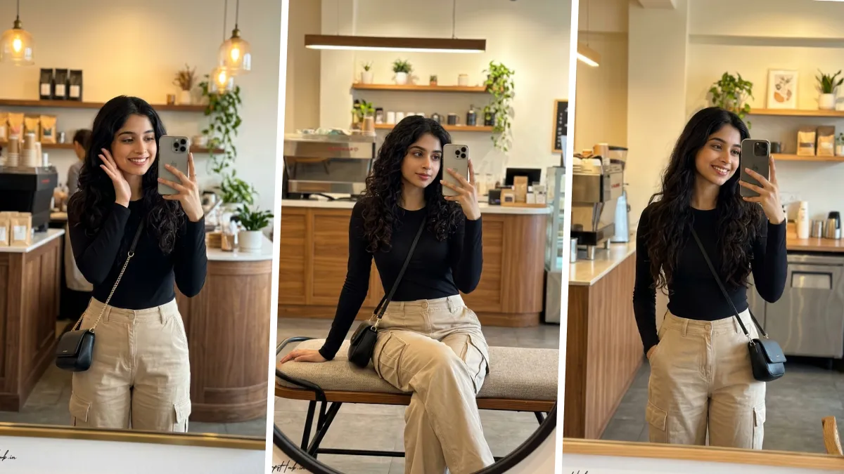 Ultra realistic café mirror selfie portrait of a stylish young woman wearing a black fitted top and beige cargo pants in a modern coffee shop setting