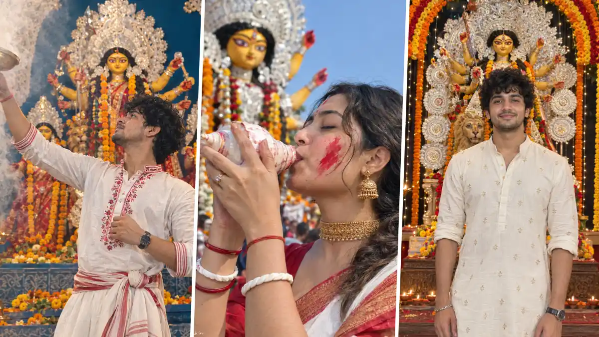Indian men and women celebrating Durga Puja in traditional Bengali outfits at a decorated Durga idol pandal