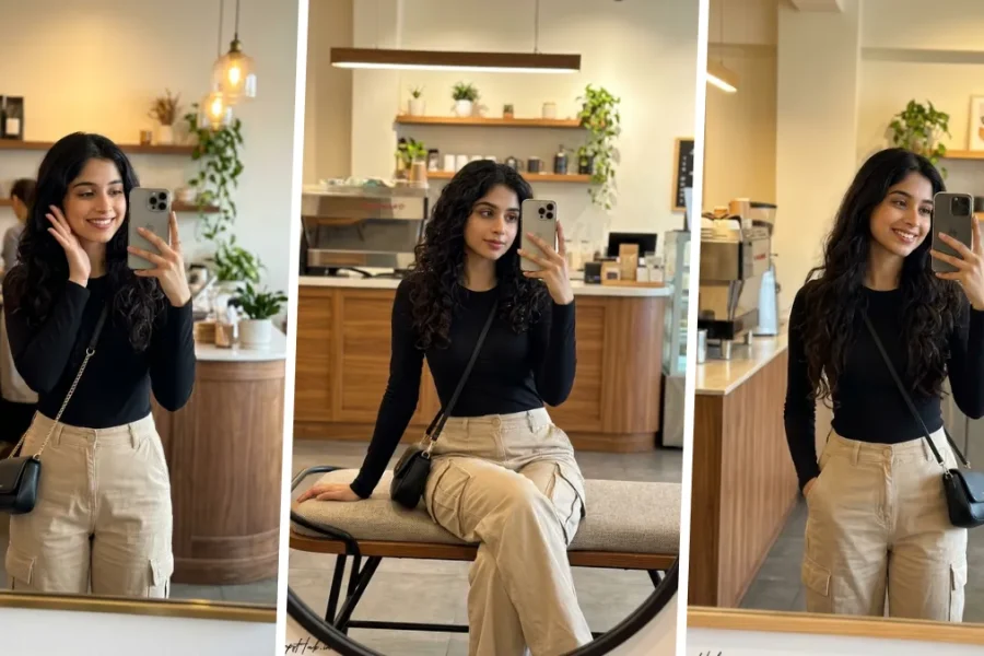 Ultra realistic café mirror selfie portrait of a stylish young woman wearing a black fitted top and beige cargo pants in a modern coffee shop setting