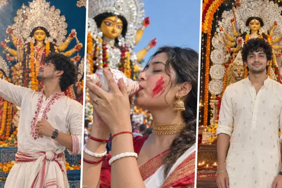 Indian men and women celebrating Durga Puja in traditional Bengali outfits at a decorated Durga idol pandal